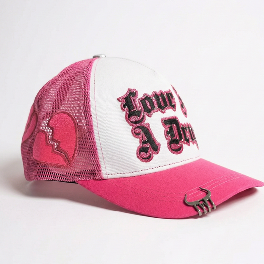 LOVE IS A DRUG TRUCKER HAT (PINK)